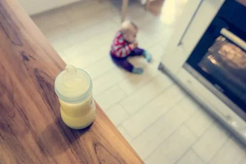 Baby playing in the kitchen. Stock Photos
