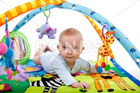 Baby playing on mat Stock Photos