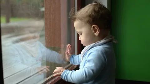 Baby playing near the window  Stock Footage 61925395