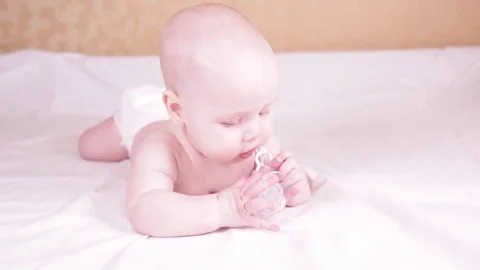 The baby is playing with the pacifier. close-up. slow-motion Stock Footage 82716729