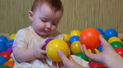 Baby playing with plastic balls Stock Footage 975808