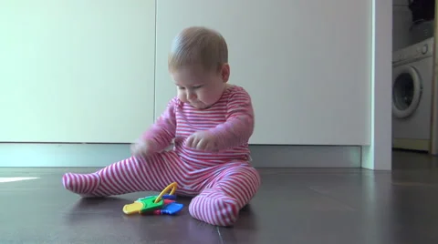 Baby playing with plastic keys Stock Footage 44121164