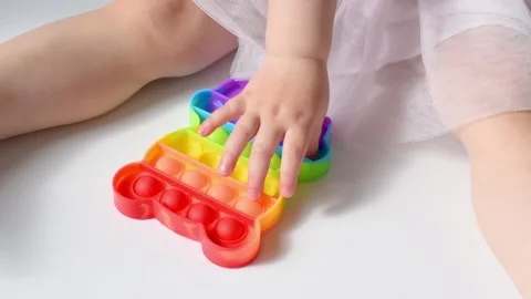 Baby playing pop it Stock Footage 154806481