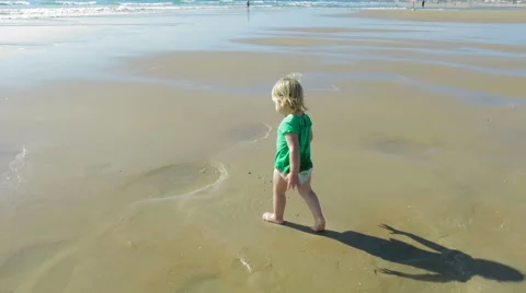 Baby playing in puddle at beach Stock Footage 58250613