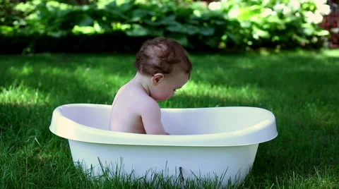 Baby playing with tablet in the bath  Stock Footage 64944037