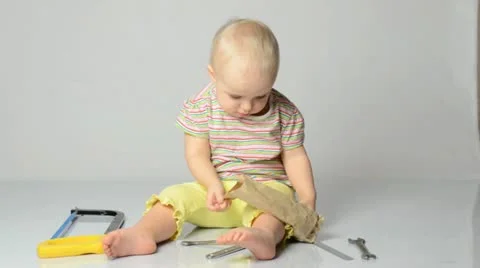 Baby playing with tools Stockbeeldmateriaal 22009924