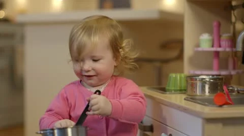Baby playing with toy kitchen Stock Footage 22067696