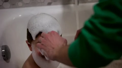 A Baby Plays With Bubbles While Taking a Bath Stock Footage 61004243