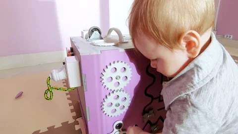 Baby plays with busy cube Stock Footage 109434388