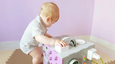 Baby plays with busy cube Stock Footage 111478611