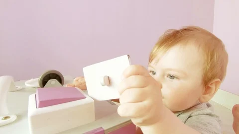 Baby plays with busy cube Stock Footage 111722110