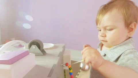 Baby plays with busy cube Stock Footage 112389372