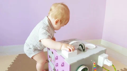 Baby plays with busy cube Stock Footage 114747357