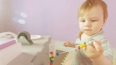 Baby plays with busy cube Stock Footage 115968545