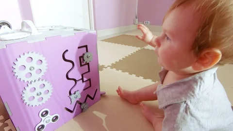 Baby plays with busy cube Stock Footage 117428333