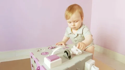 Baby plays with busy cube Stock Footage 120927742
