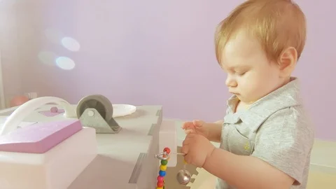 Baby plays with busy cube Stock Footage 122331348