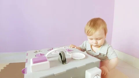 Baby plays with busy cube Stock Footage 124596454