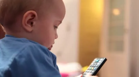 Baby plays with the remote control. Stock Footage 8860768
