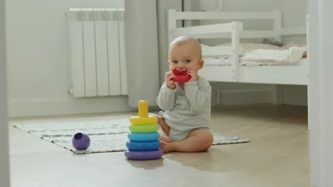 A baby plays with a toy Stock Footage