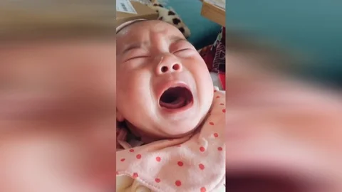 Baby pretends to cry to get parents Stock Video Pond5