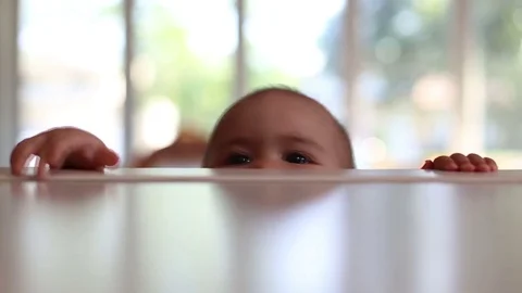 Baby pulling herself up, video Video stock 79074433