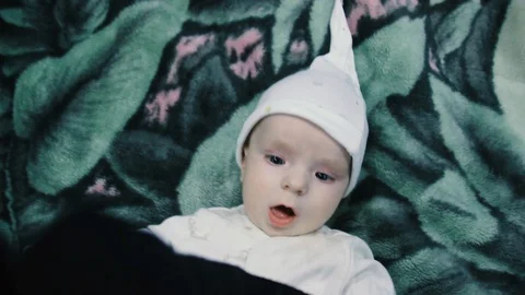 The baby pulls the strap of the camera. View from above Stock Footage 102032185