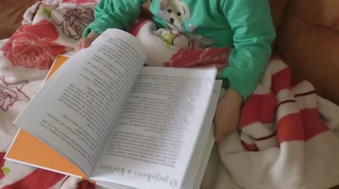 Baby reading book on sofa 스톡 동영상 48802630