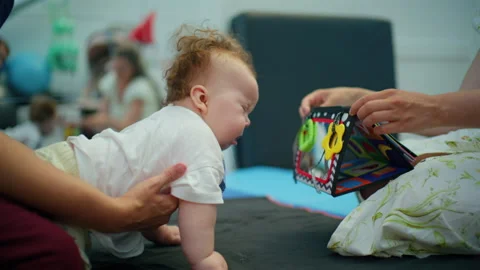 Baby receiving physical therapy, improving motor skills and development with Stock-Footage 342861489
