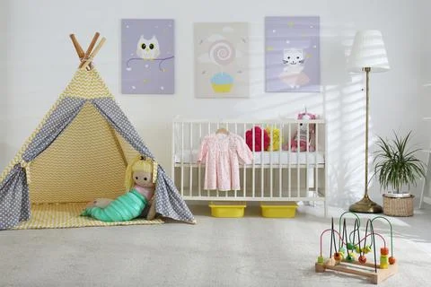 Baby room interior with cute posters, play tent and comfortable crib Stock Photos