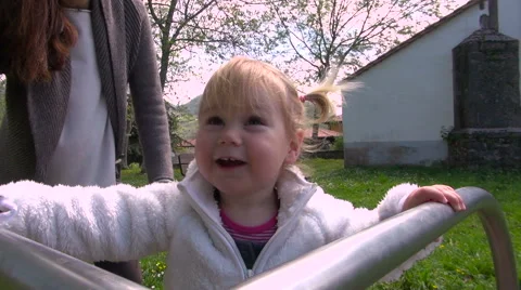 Baby rotating in playground Stock Footage 56138385