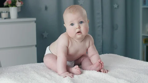 Baby sitting on a bed Stock Footage 87837523