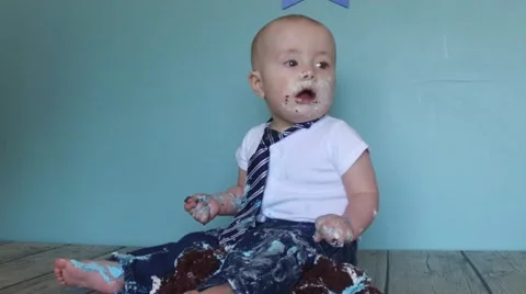 Baby sitting in cake Stock Footage 61926535