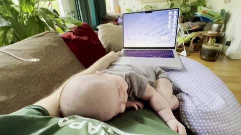 Baby sleeping on belly while working on computer Stock Footage 265324593