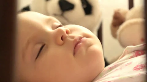 A baby sleeping in a cradle Stock Footage 30761468