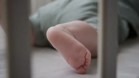 Baby Sleeping in Crib with Tiny Bare Foot Moving at Home Vídeos de archivo 346595679
