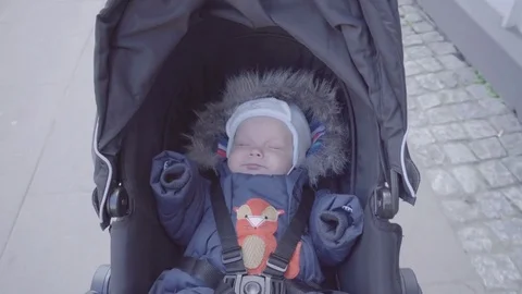 The baby is sleeping in the stroller Video stock 76622967