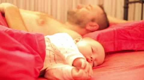 Baby sleeps peacefully his father wake up Stock Footage 59776627
