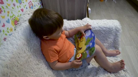 Baby with a small book Stock Footage 62952059