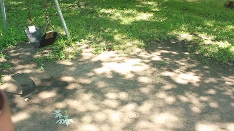 Baby smiles and kicks while swinging Stock Footage 7753811