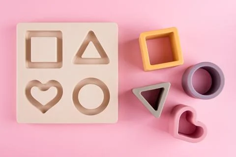 Baby soft nesting sorting ans stacking toy for arranging by color and geometr Stock Photos