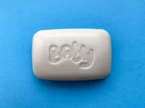 Baby solid soap for hands on a blue background. Hygiene and care. Foto stock