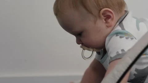 Baby spits out pacifier Stock Footage 304998760
