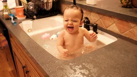 Baby Splashing and Having Fun in Sink for Bath Time Stock Footage
