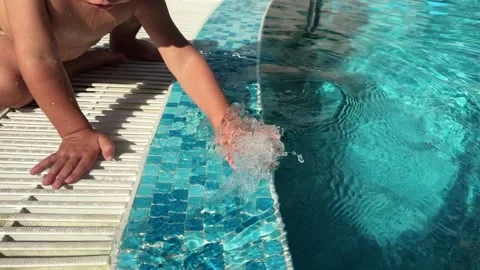 A baby is splashing in the pool Stock Footage 317517976