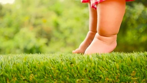 Baby start leaning walking first time on green grass Stock Footage