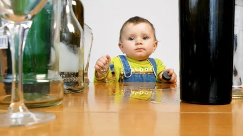 Baby surrounded by empty bottles. Сhild abuse Stock Footage 101360768