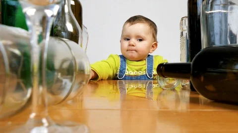 Baby surrounded by empty bottles. Сhild abuse. Stock Footage 101360812