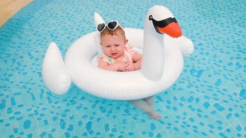 Baby swims in the pool in a circle. Selective focus. Stock Footage 153259948