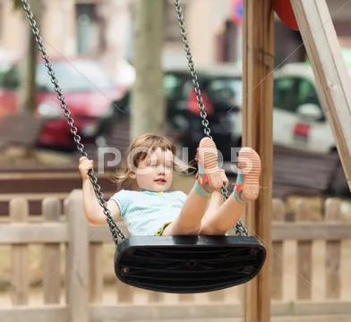 Baby on swing in city Stock Photos